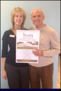 Sheila and Ronnie Sadler hold a poster indicating their business is a sponsor of The Way.
